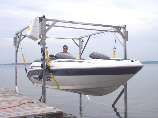 Portable boat lift with boat and man inside